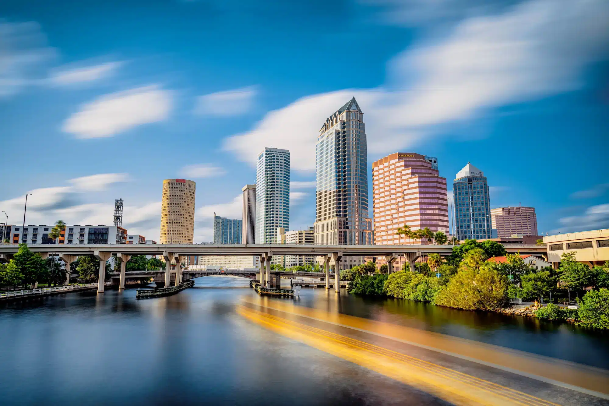 Tampa skyline with the Hillsborough River and a bridge, showcasing the vibrant cityscape where Massaro Law, a personal injury attorney, serves clients.